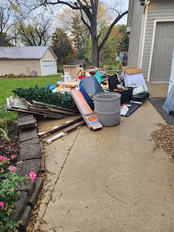 Dumpster being loaded with debris for Estate Cleanout Dumpster Rental in Southern Pines